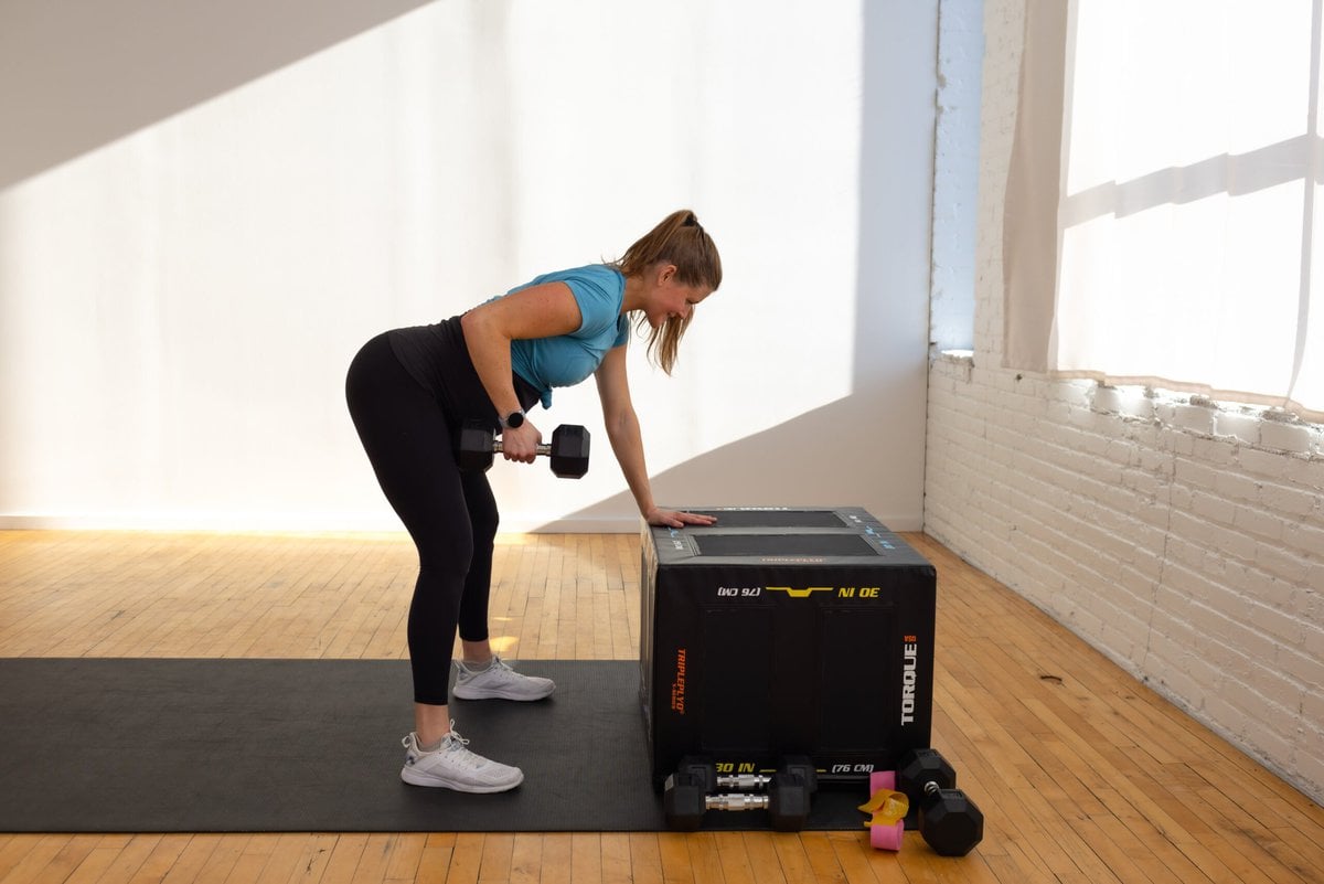 pregnant woman performing bent over back row as part of a prenatal strength training workout