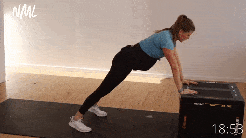 pregnant woman performing an incline push up shoulder tap; exercise for pregnant women