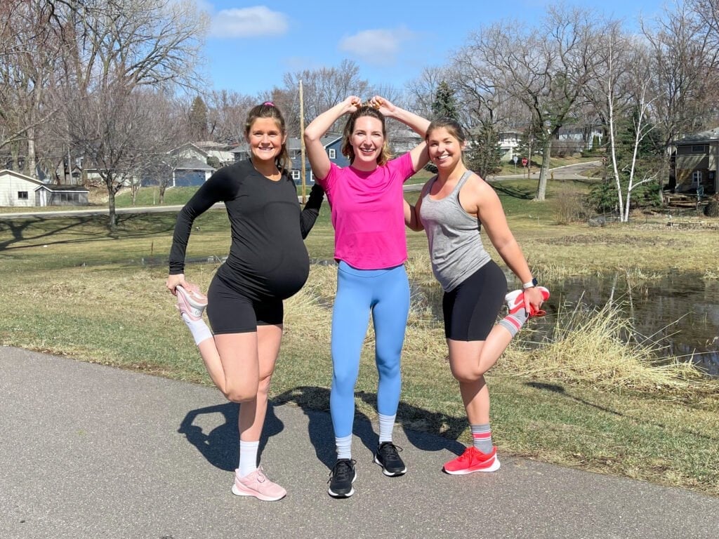 3 women wearing running gear on outdoor running trail 