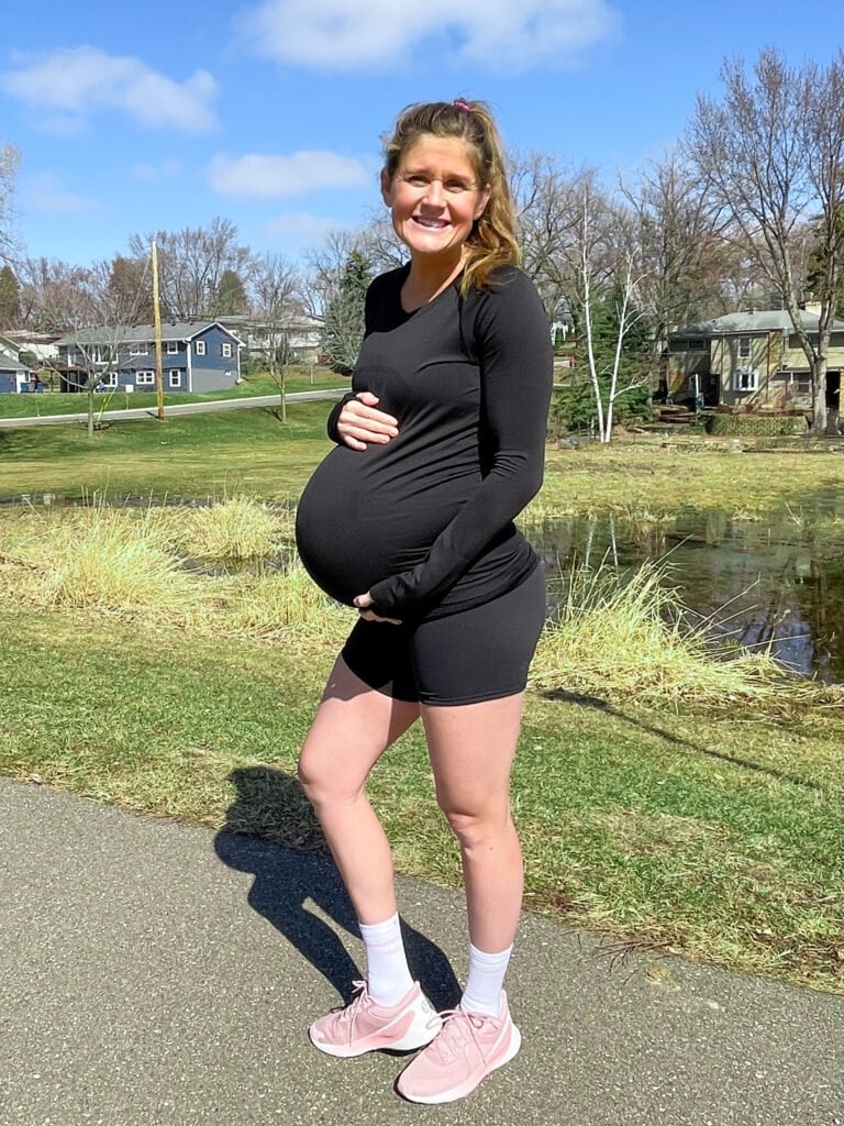 pregnant woman wearing black long sleeve running shirt