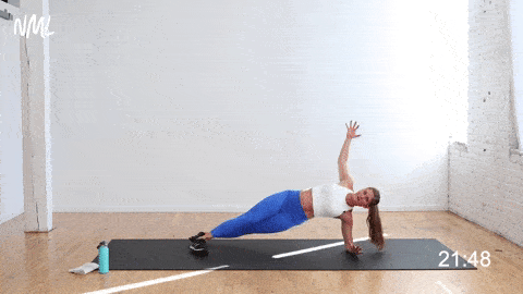woman performing a side plank and reach open