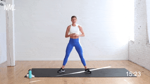woman performing sumo squat calf raise as part of bodyweight workout