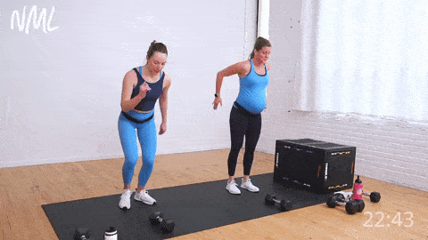 two women (one pregnant woman) performing a low squat walk to V
