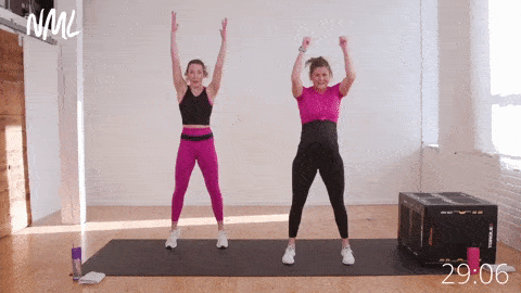two women performing swing squats or air squats with arms swinging overhead, low impact cardio exercise