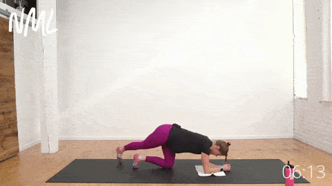 pregnant woman performing Curtsy Leg Lifts in quadruped position on mat. 