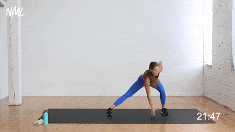 woman performing a lateral lunge jump switch as part of full body hiit workout