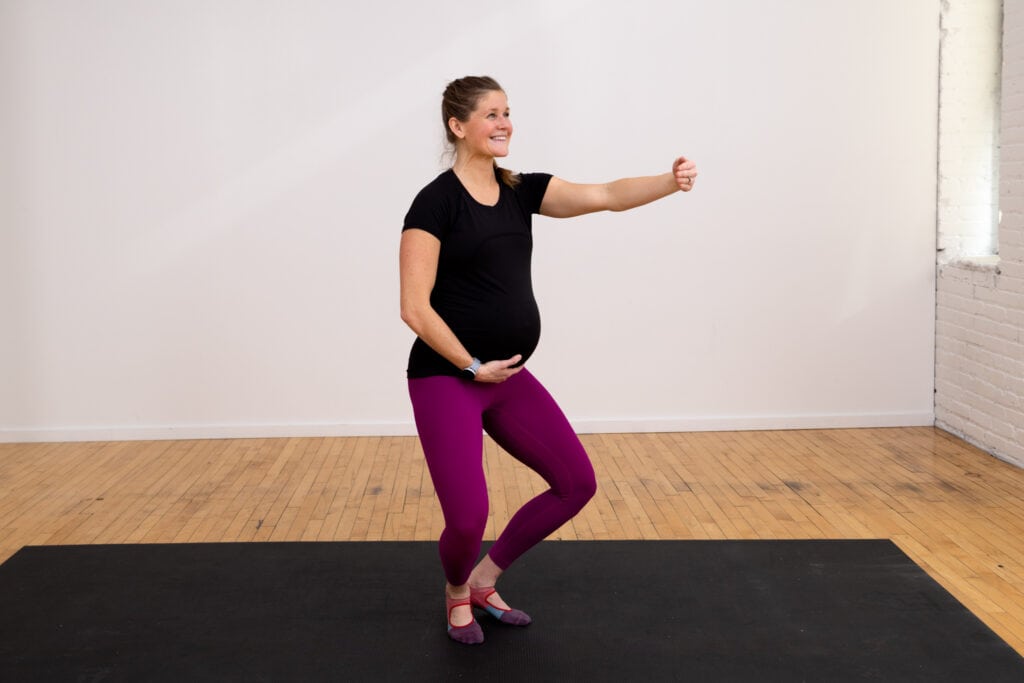 pregnant woman performing a first position arm lift