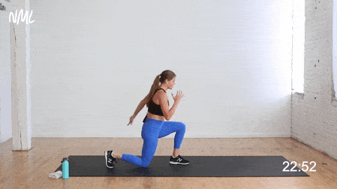 woman performing reverse lunge kick and front kick as part of bodyweight hiit workout