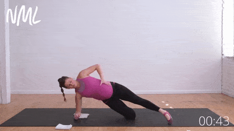 pregnant woman performing modified side plank and leg lift rainbows