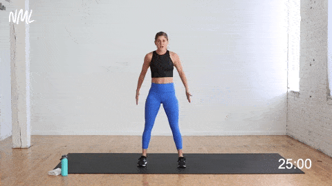 woman performing a two pulse squats as part of bodyweight hiit workout