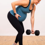 pregnant woman performing back row exercise