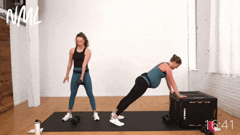 pregnant woman performing a modified push up and burpee using a box to reduce abdominal pressure