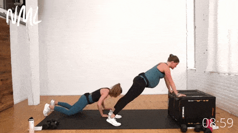 pregnant woman performing modified plank and push ups 