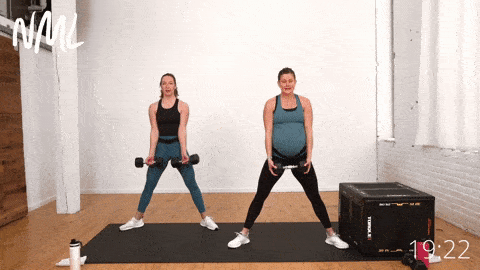 pregnant woman performing a sumo squat with added bicep curl as part of best pregnancy exercises workout