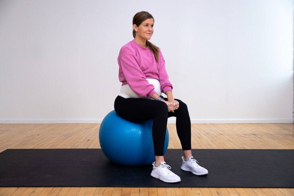 pregnant woman sitting on an exercise ball activating adductors to relieve pelvic pain during pregnancy