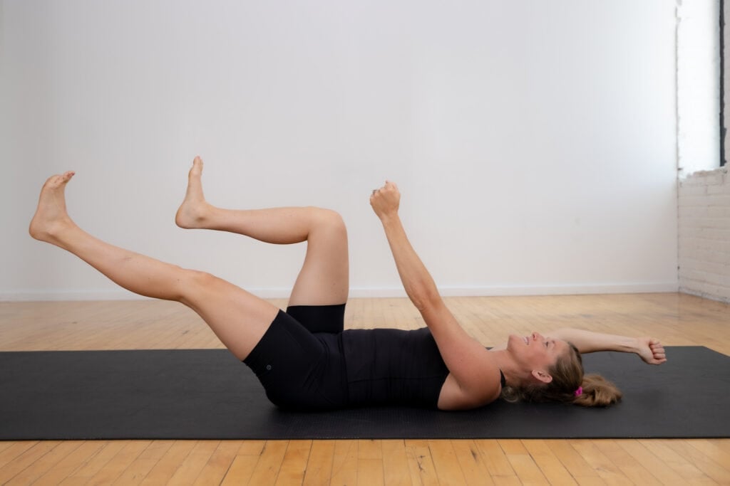 postpartum woman performing a beginner dead bug exercise to rebuild core strength