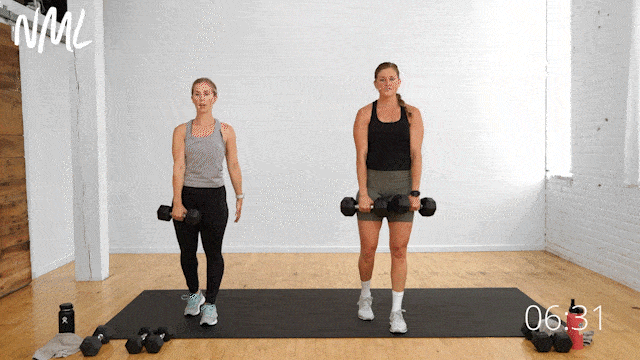 two women performing a staggered deadlift with dumbbells