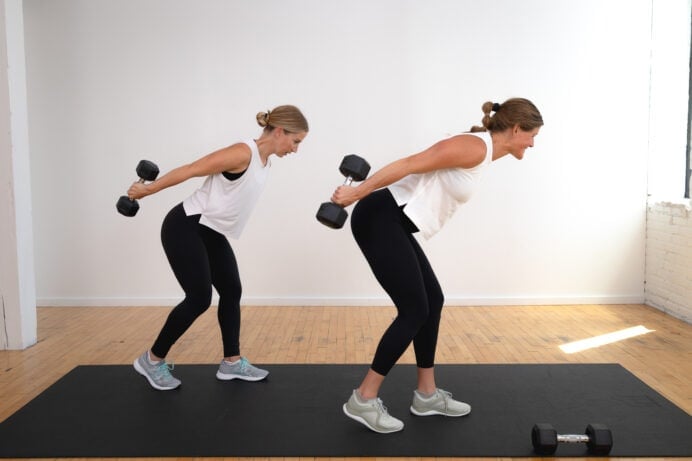 two women performing a standing tricep kickback as part of beginner arm workout