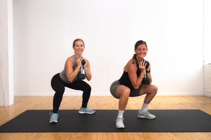 two women performing a pivot squat as part of beginner leg day workout