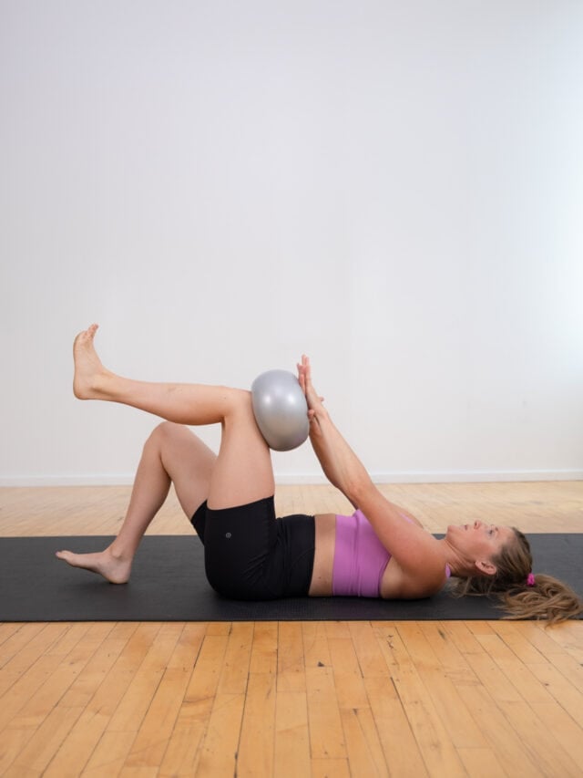 pilates ball hold and press as part of pilates ab workout
