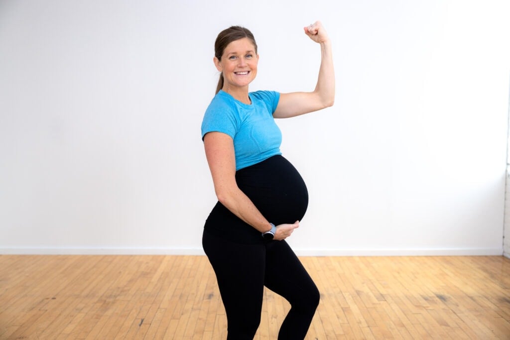 pregnant woman flexing as part of labor inducing workout
