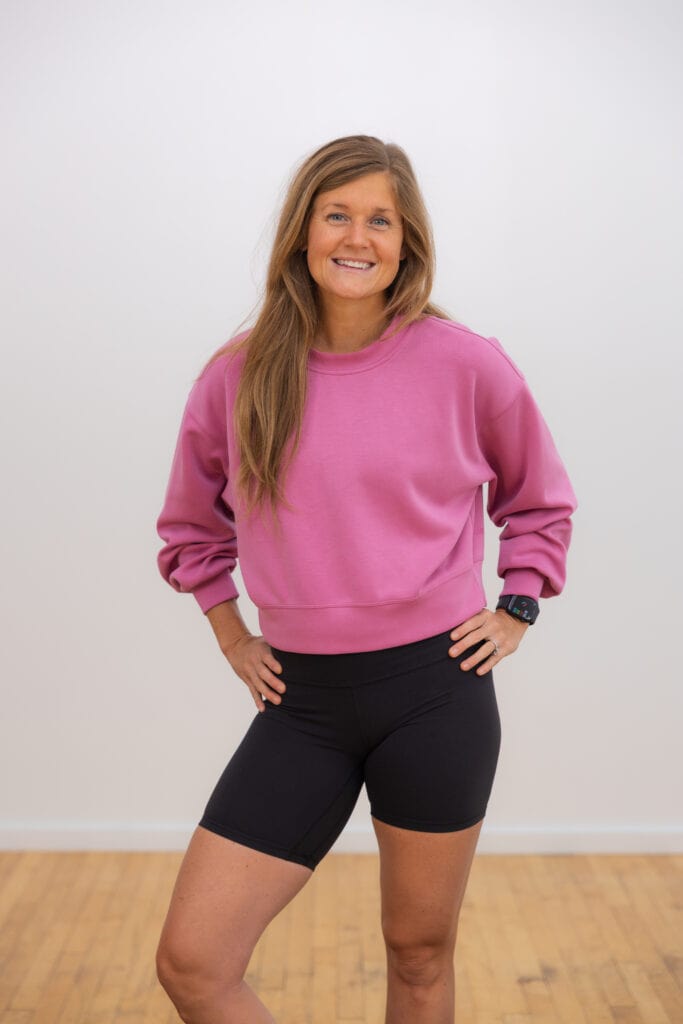 woman wearing pink cropped lululemon sweatshirt