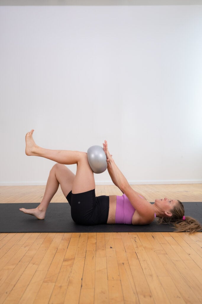 pilates ball hold and press as part of pilates ab workout