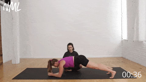 postpartum woman performing plank and arm reach
