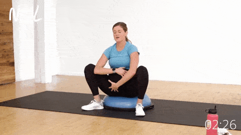 pregnant woman in a low yogi squat to open hips and relax pelvic floor