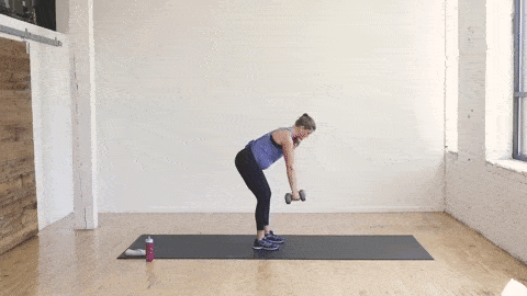 pregnant woman performing a bent over back row and tricep kickback in a dumbbell arm workout