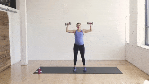 pregnant woman performing a goal post chest tap and alternating shoulder press in a dumbbell arm workout