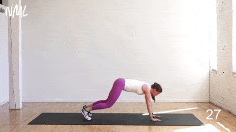 woman performing a plank launcher and push up in an advanced ab workout for women