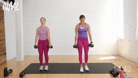 two women performing reverse lunges to target the legs and glutes as part of dumbbell workout for beginners