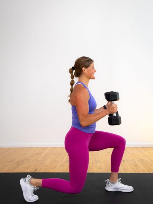 woman performing a lunge and bicep curl