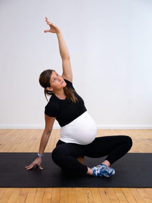 pregnant woman sitting in low squat to prepare for labor