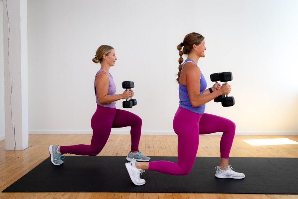 two women performing a reverse lunge with dumbbells as part of beginner strength workout