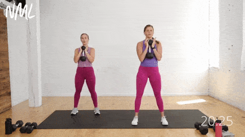 two fit women performing goblet squats as part of a beginner dumbbell workout 