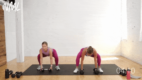 two women performing a leg and chest combo exercise on a black mat as part of dumbbell workout for beginners