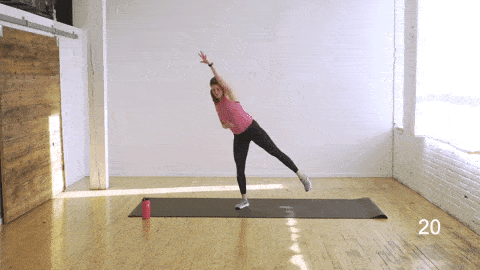 woman performing balance oblique crunches in an abs and butt workout
