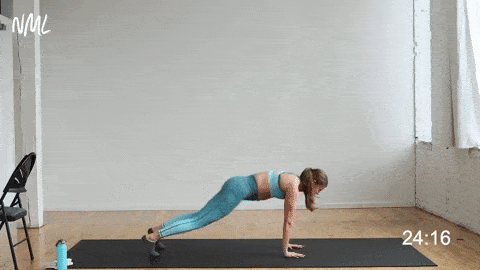 woman performing a launcher plank in a cardio barre workout at home