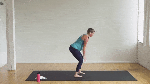 pregnant woman performing a rear kick and arm fly in a cardio barre workout