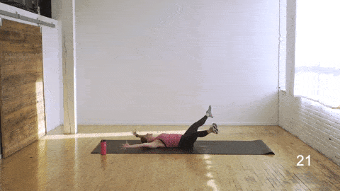 woman performing a total body crunch in an abs and butt workout