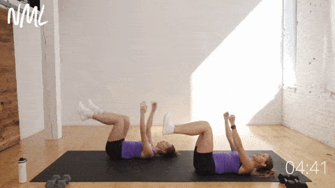 two women lying on their backs showing a standard dead bug exercise