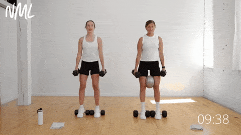 two women performing heels elevated squat as part of inner thigh workout