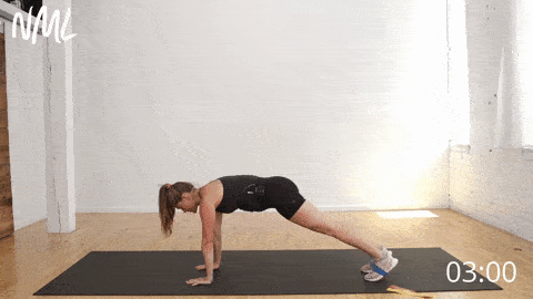 postpartum woman performing a plank with a resistance band as example of postpartum ab exercise