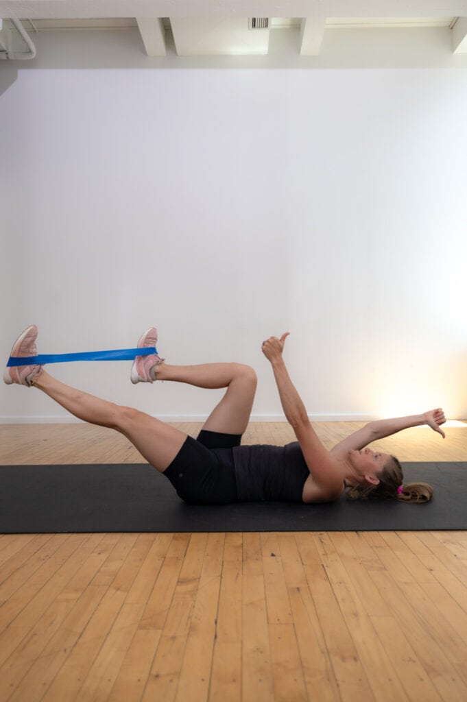 postpartum woman performing a dead bug exercise to repair diastasis recti