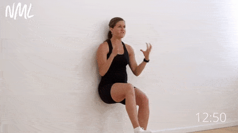 postpartum woman performing a single leg wall sit 
