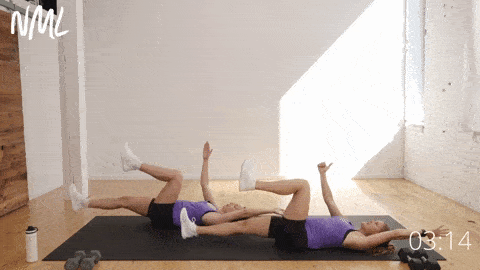 two women lying on their backs demonstrating a single sided dead bug exercise