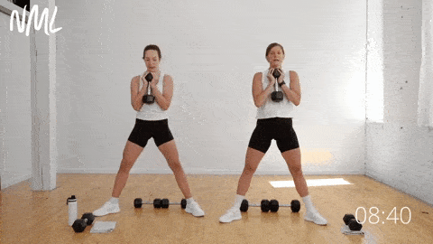 two women performing sumo squat heel raises as part of an inner thigh workout