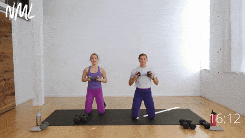 two women performing a dumbbell press out and four bus drivers in an arm and shoulder workout